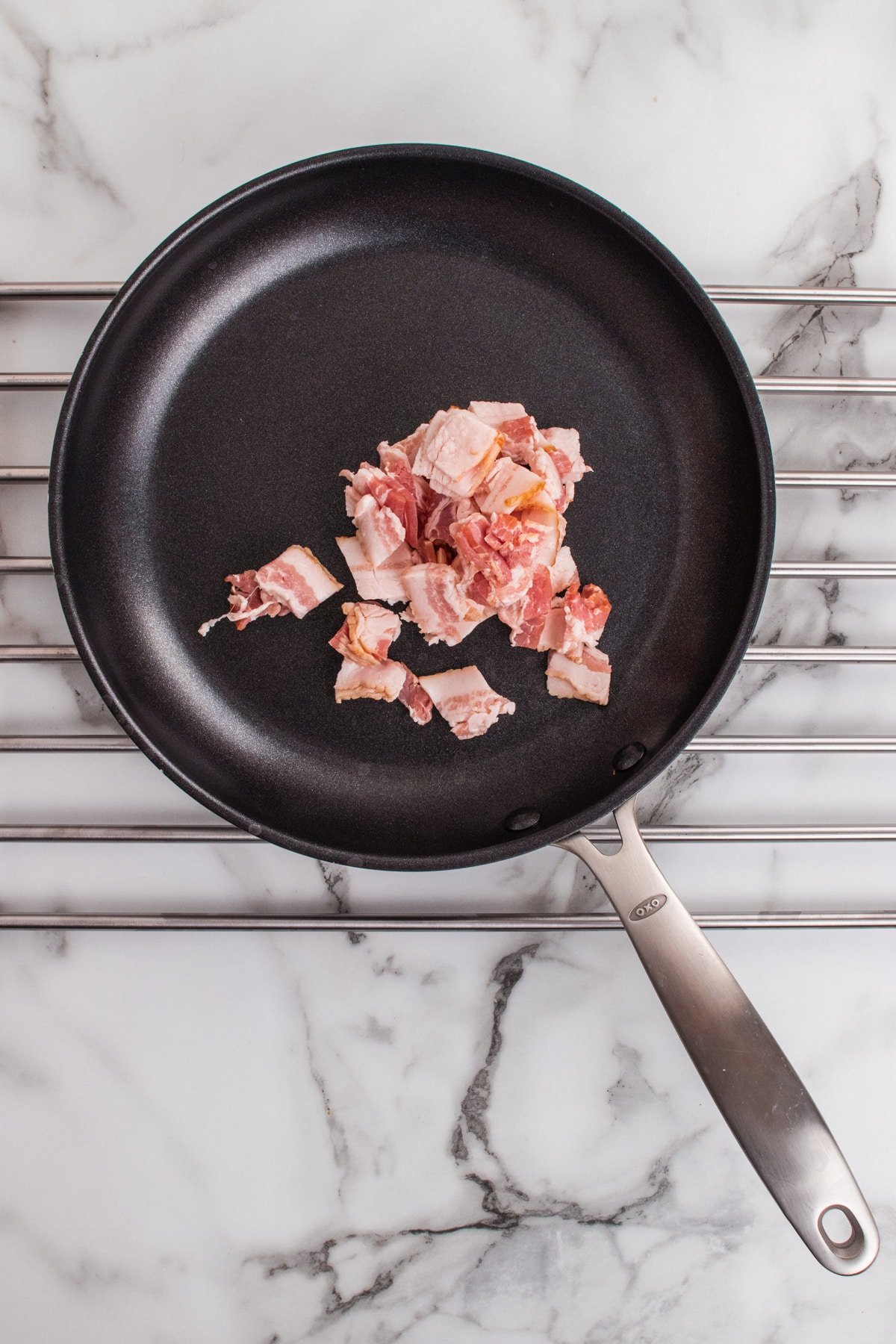 raw bacon in skillet