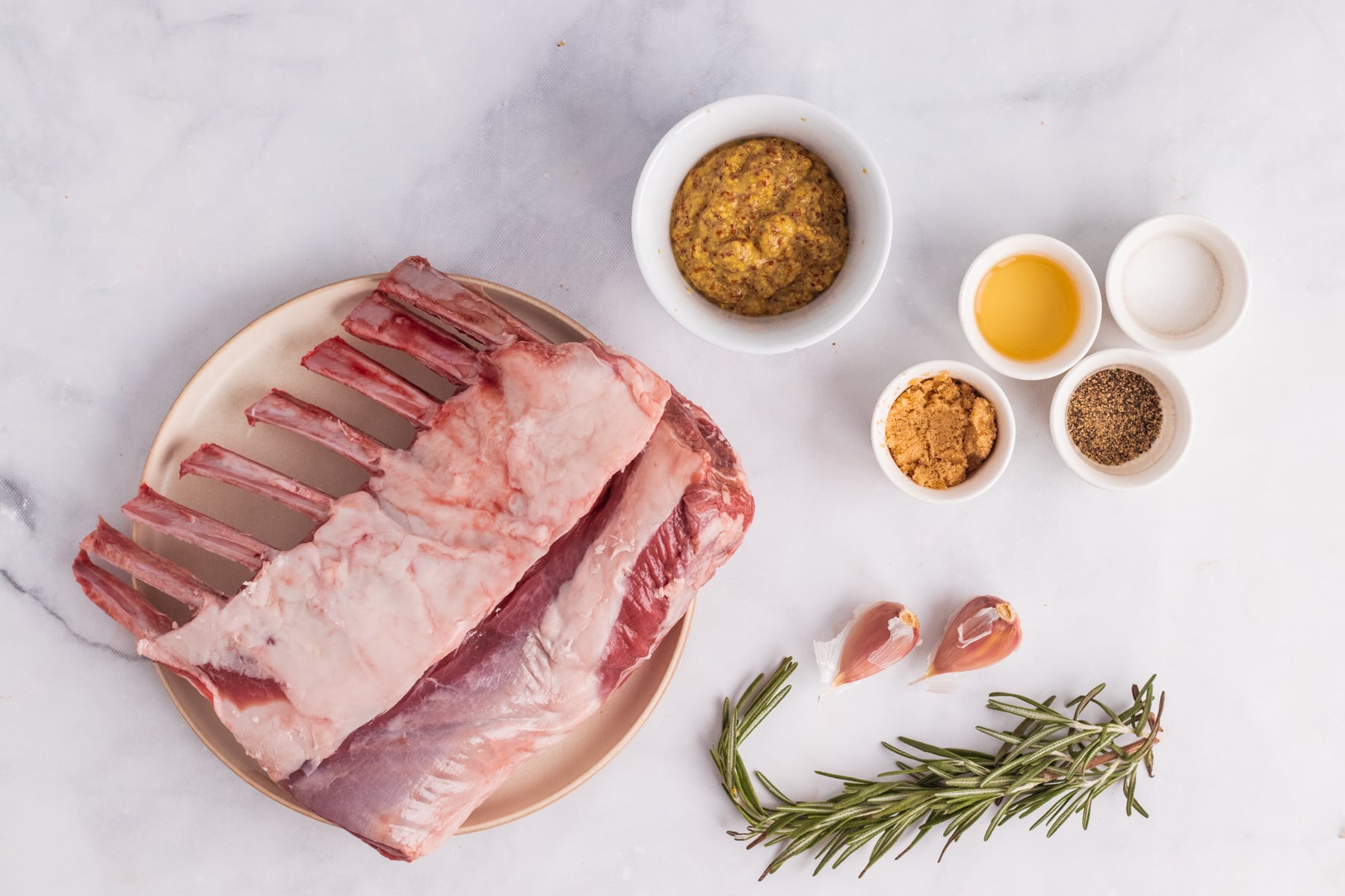 Ingredients for grilled rack of lamb on white table. 