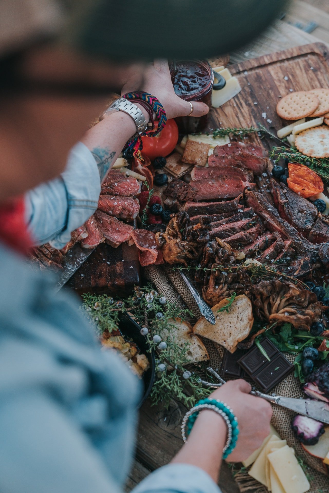 Woman assembling charcuterie board. 