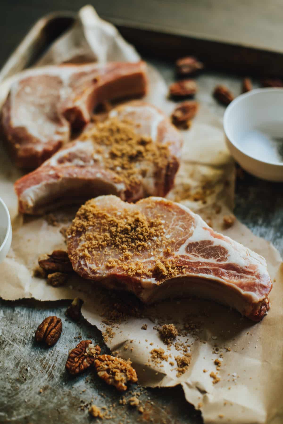 Raw pork chops coated with sugar and spices. 