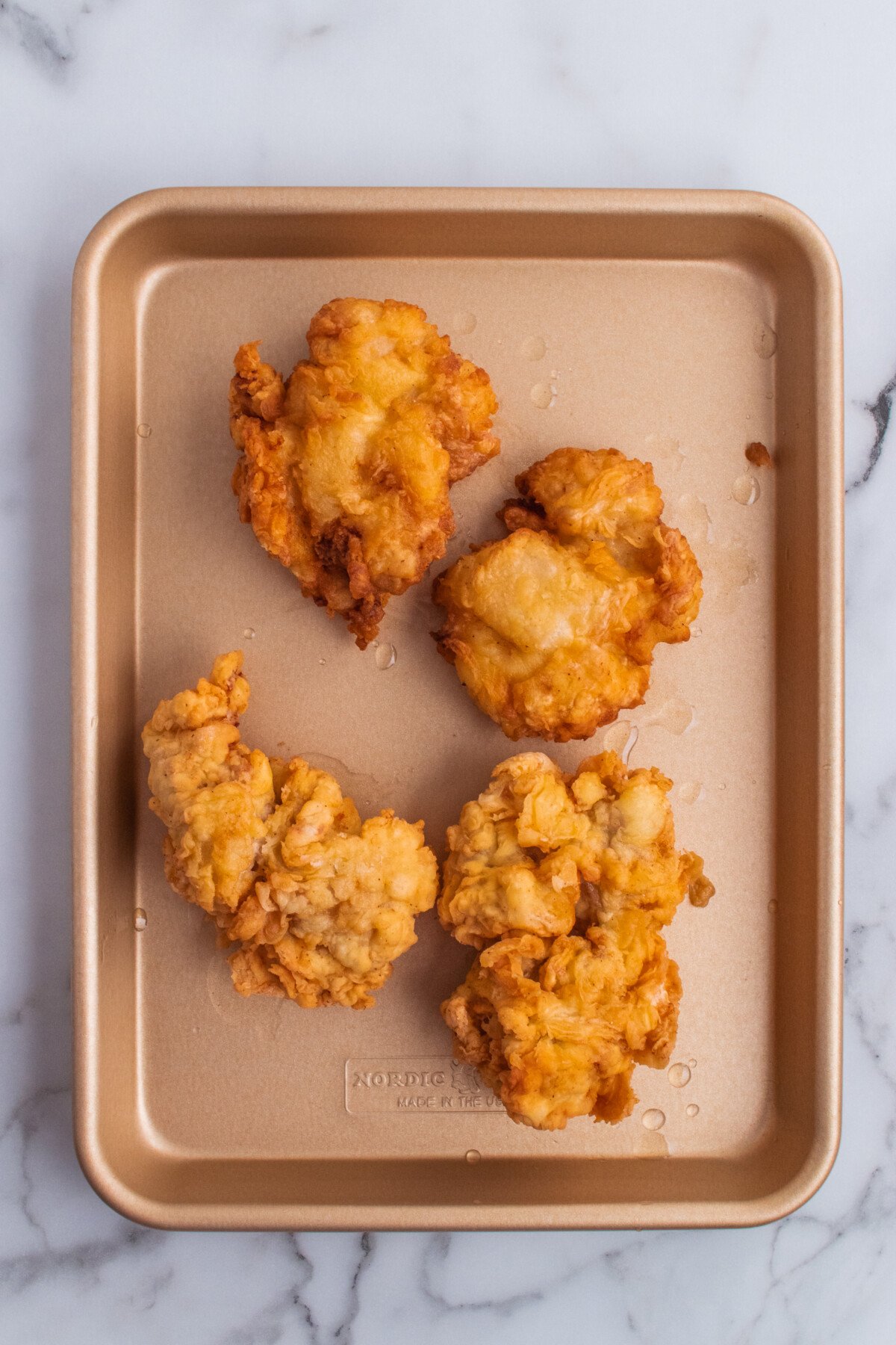 Golden fried chicken on a platter.