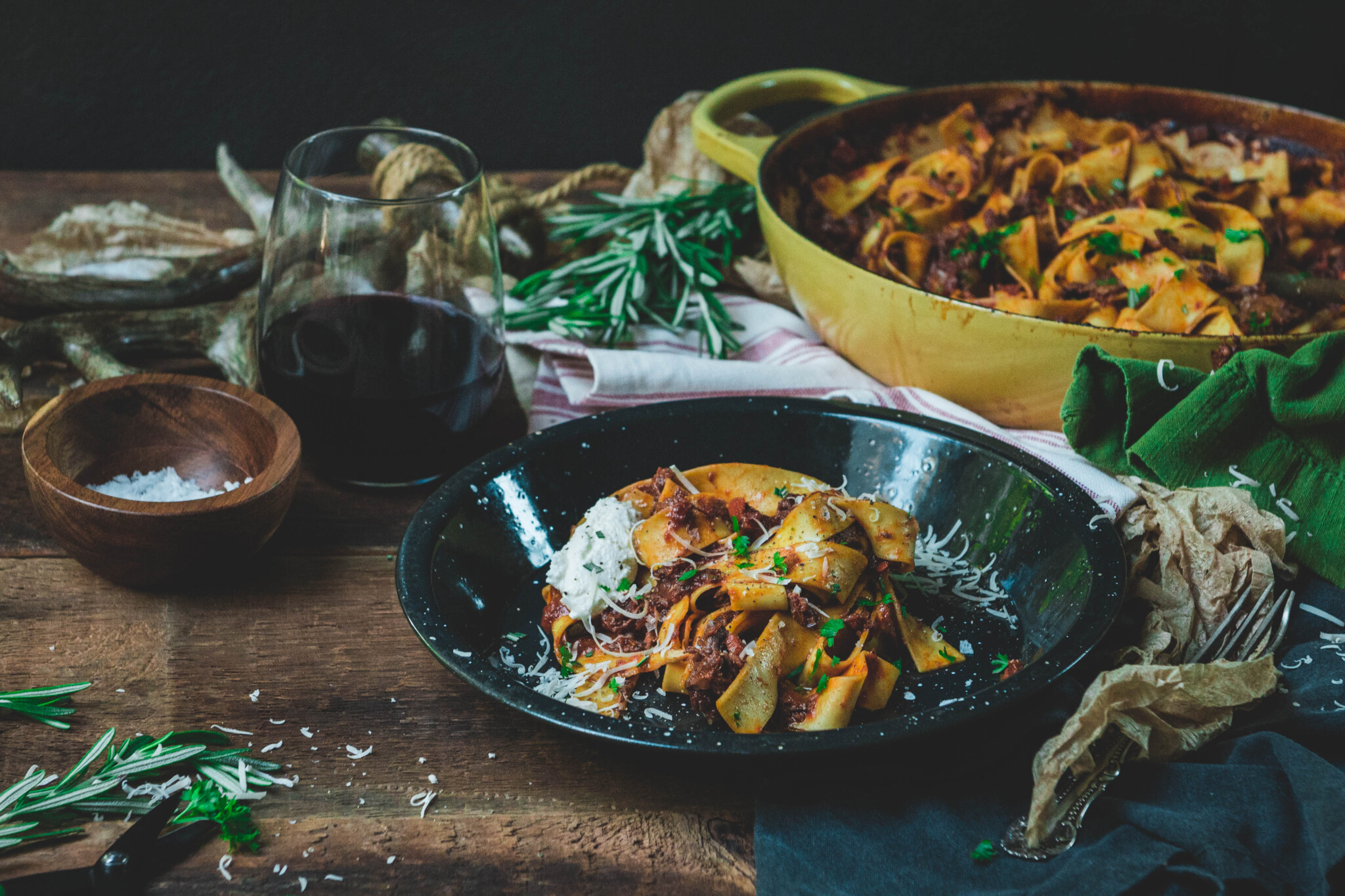 showing braised beef ragu in a platter topped with ricotta and herbs 