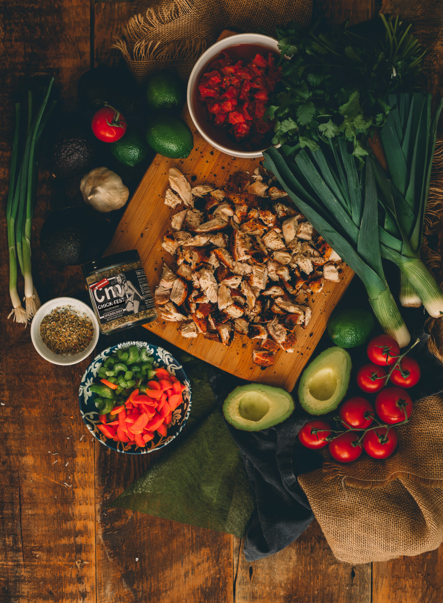 Ingredients for chicken soup with chopped leftover chicken, leeks, avocado, tomatoes, carrots, celery, tomatoes, garlic and GirlCarnivore Chick Fest spice blend. 