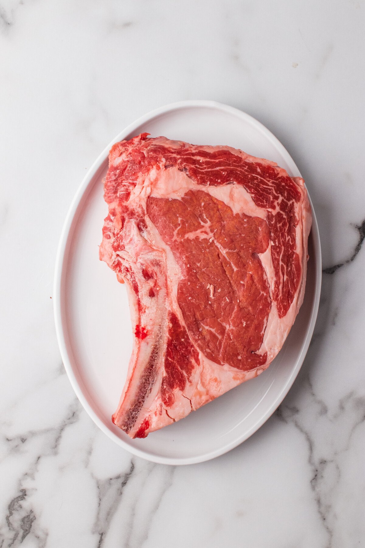 Bone-in ribeye steak on a platter. 