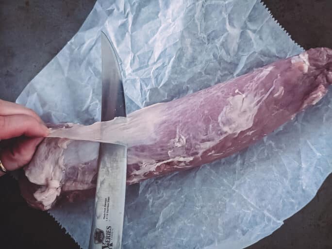 Silverskin being removed from a pork tenderloin.