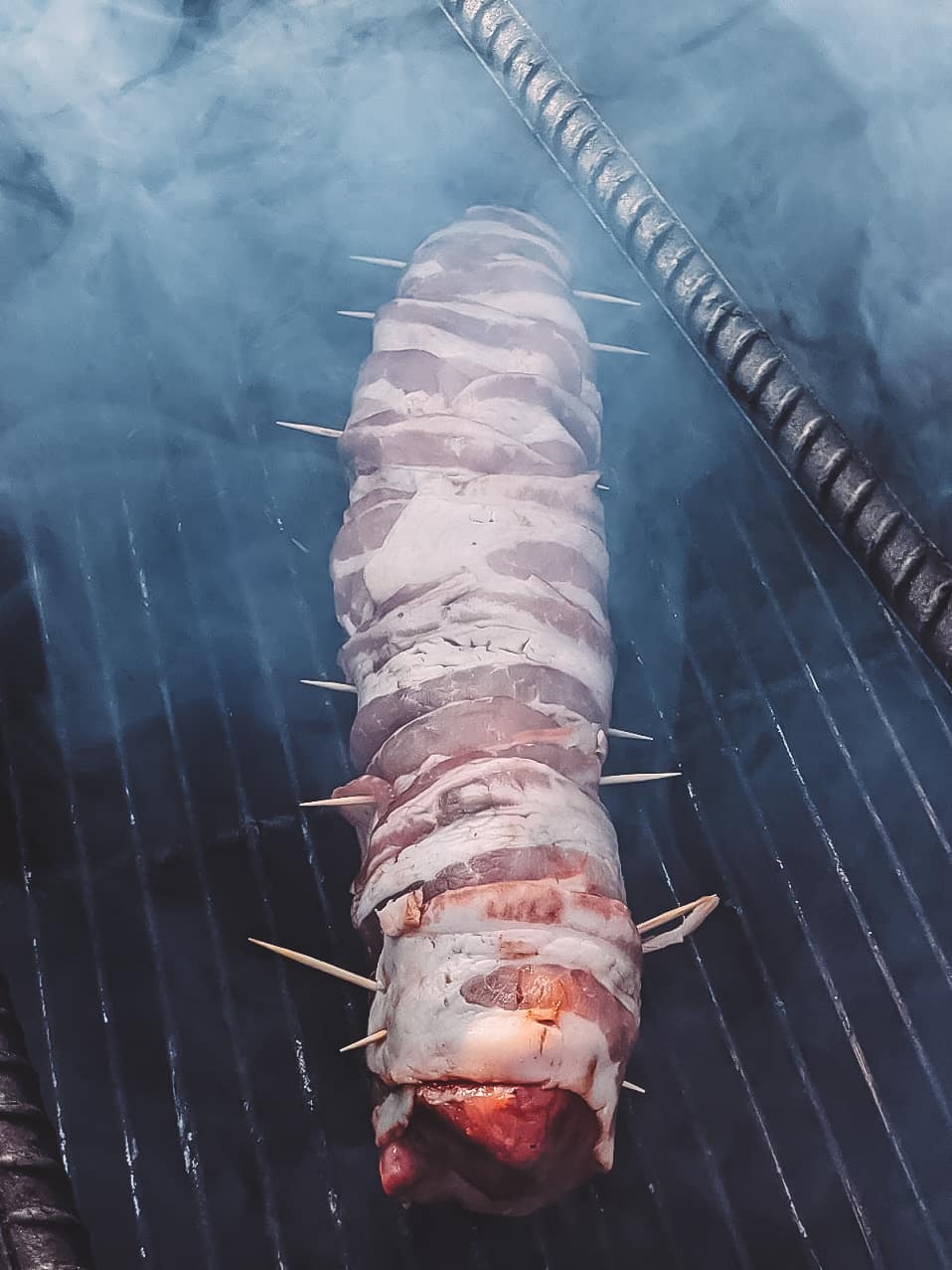 Pork tenderloin placed on the smoker. 