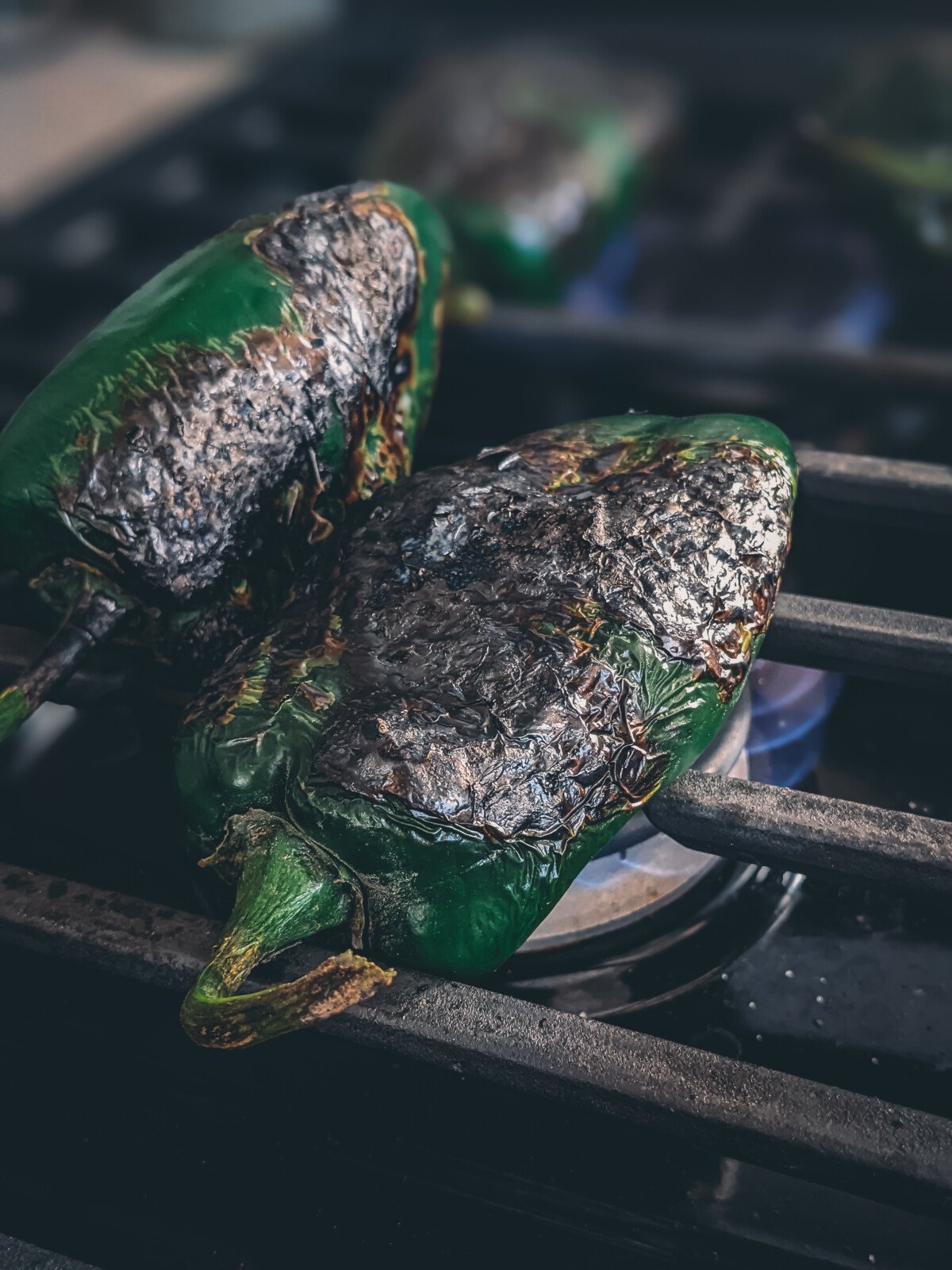 Poblano peppers being roasted on the range. 