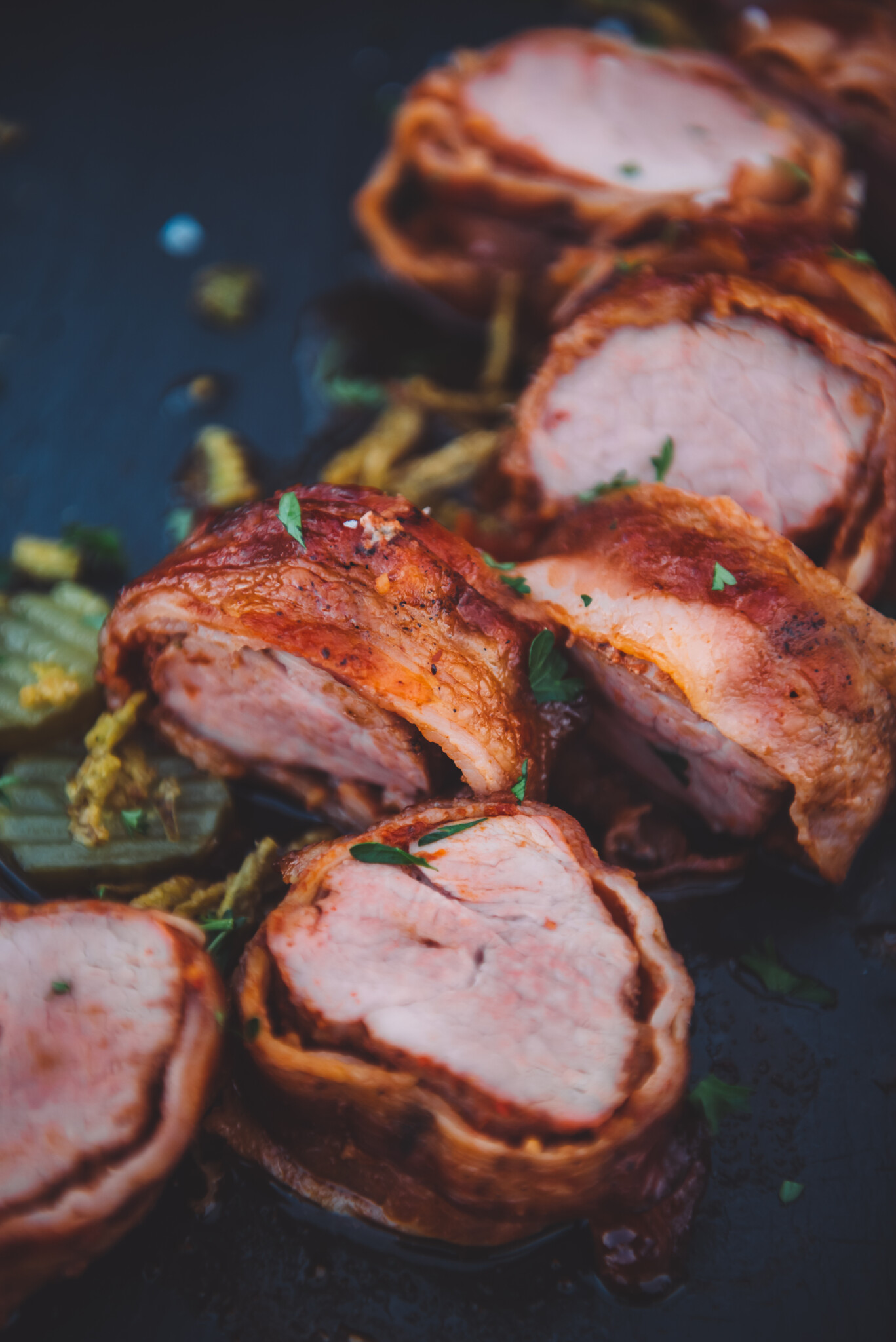 Close up to show the crispy bacon around the pork tenderloin.