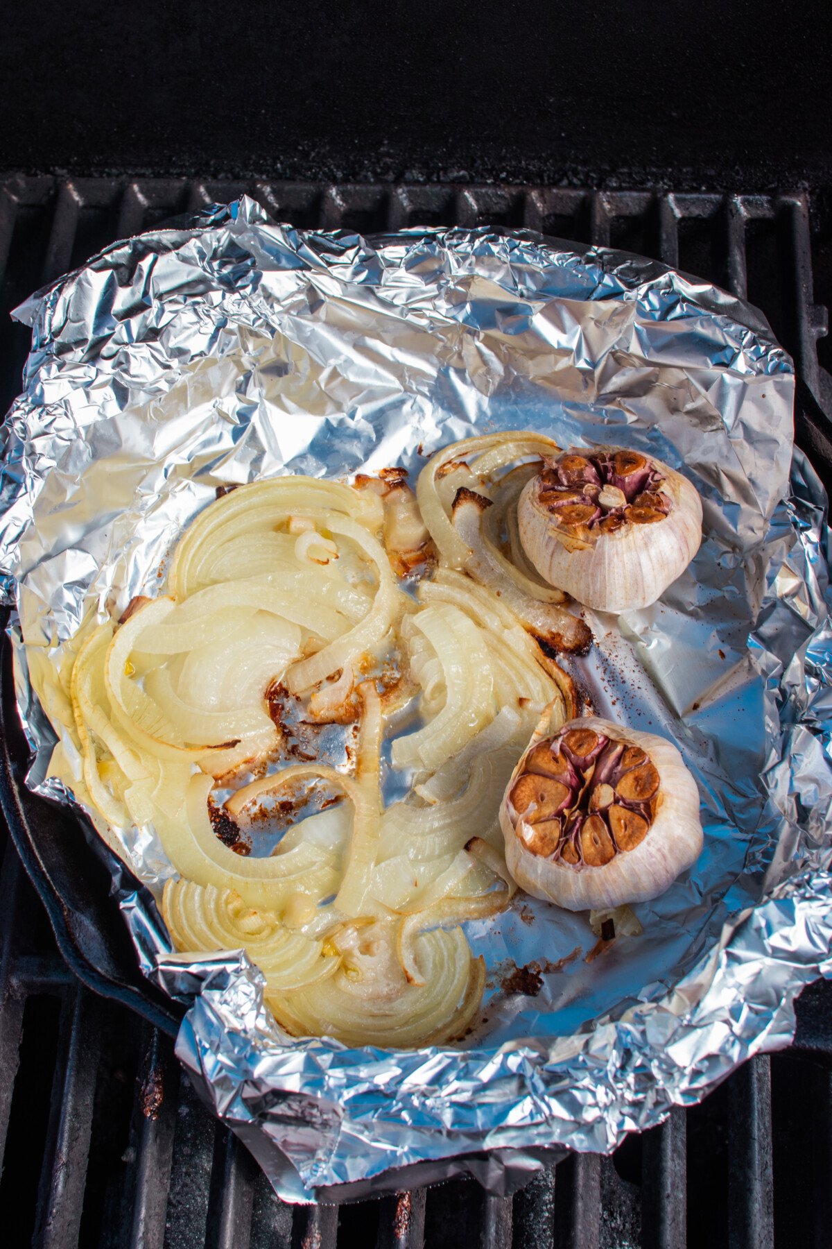 Onions and garlic cooked to golden brown in foil on grill.