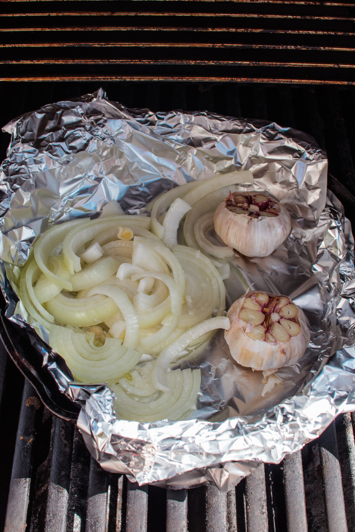 slice onions and garlic in foil on grill.