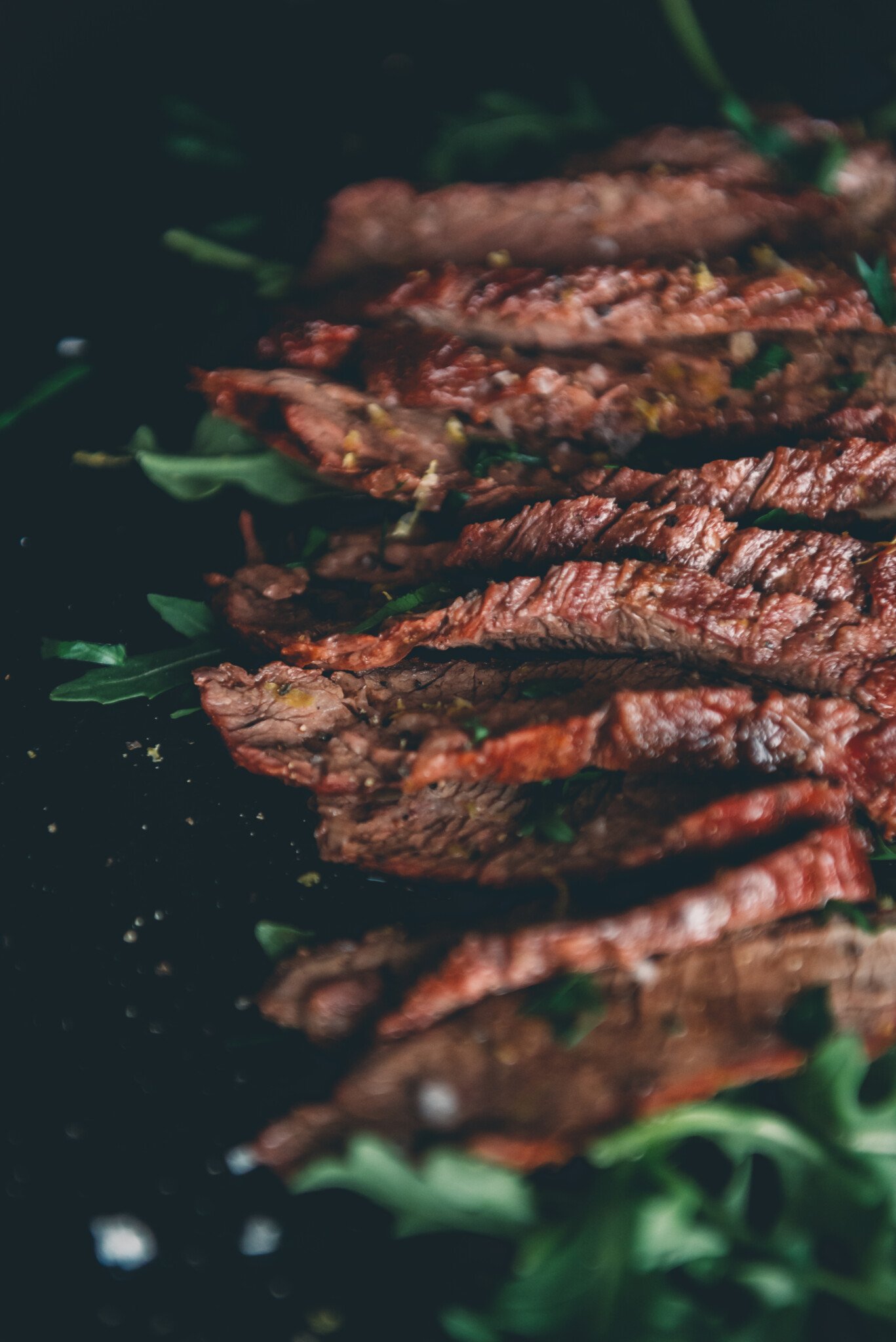 Side shot close up of a sliced bavette steak to show the gran and color. 