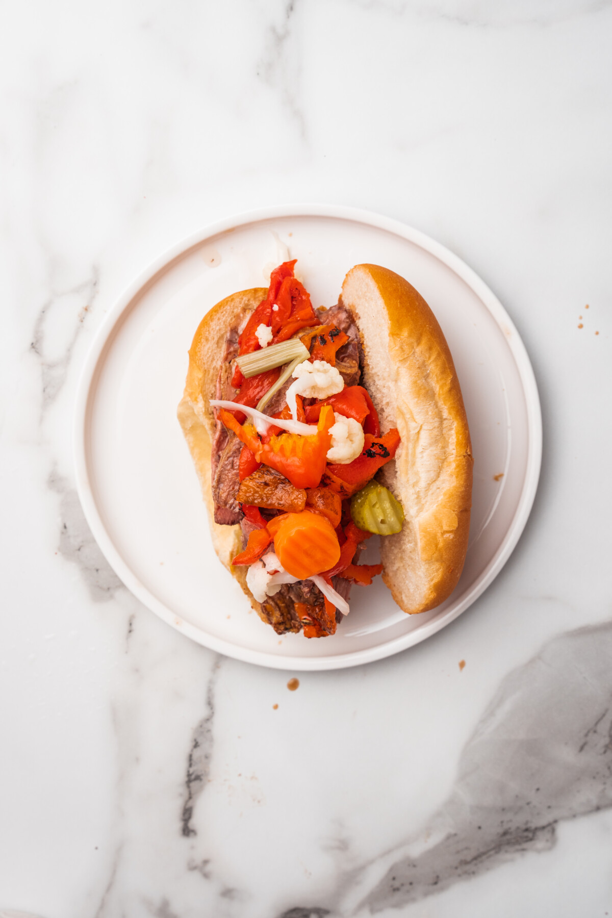 Pickled veggies on top of sliced Italian beef sandwiches.