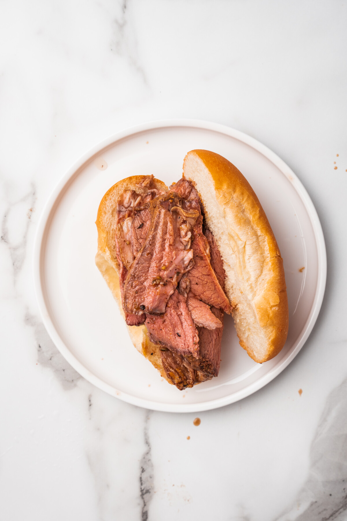 Soaked beef slices on a roll.