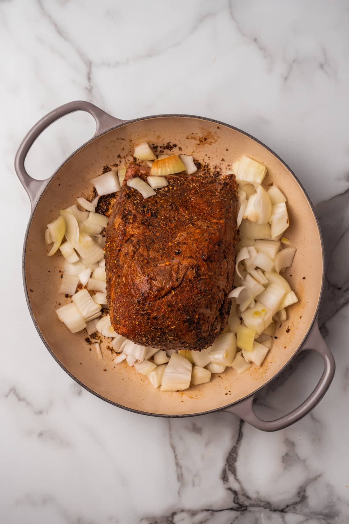 beef roast with diced onions in a large skillet.