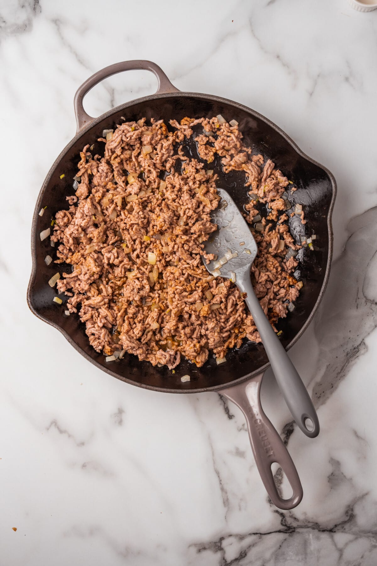 cooked ground pork in skillet for taco meat.
