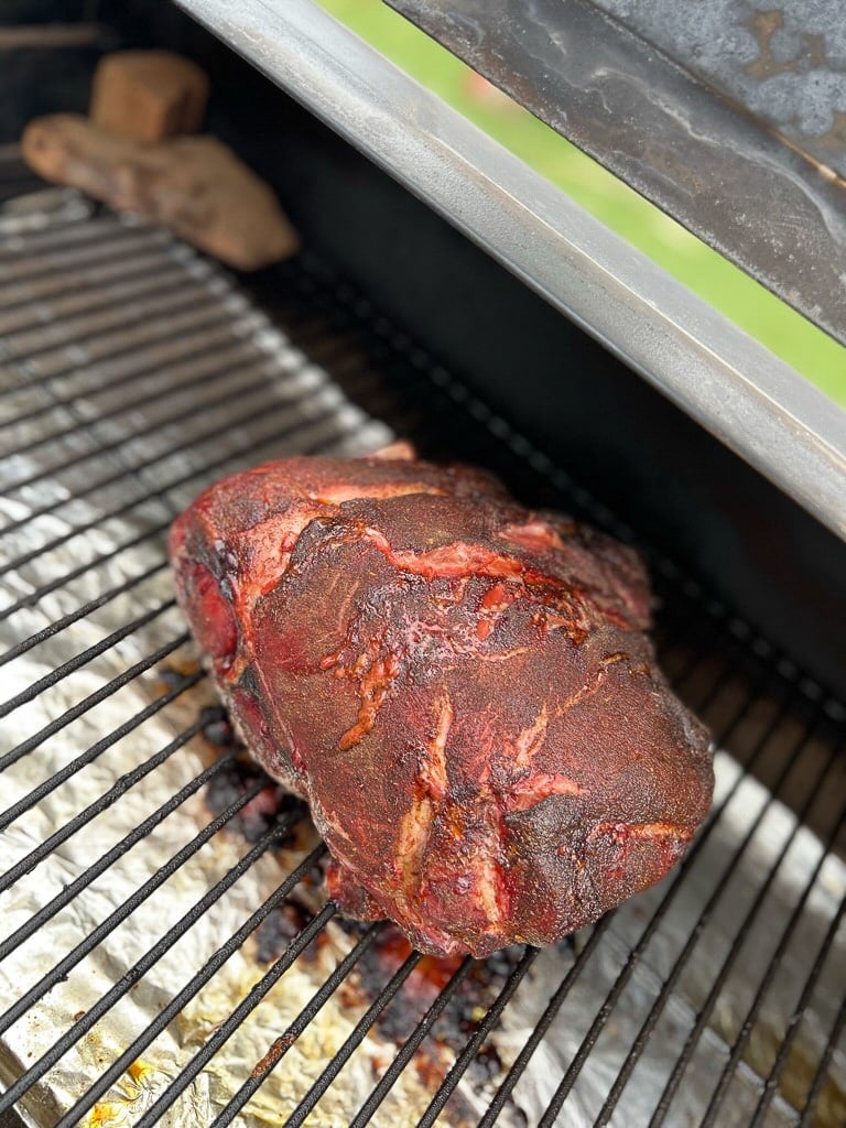 smoked pork butt on a grill