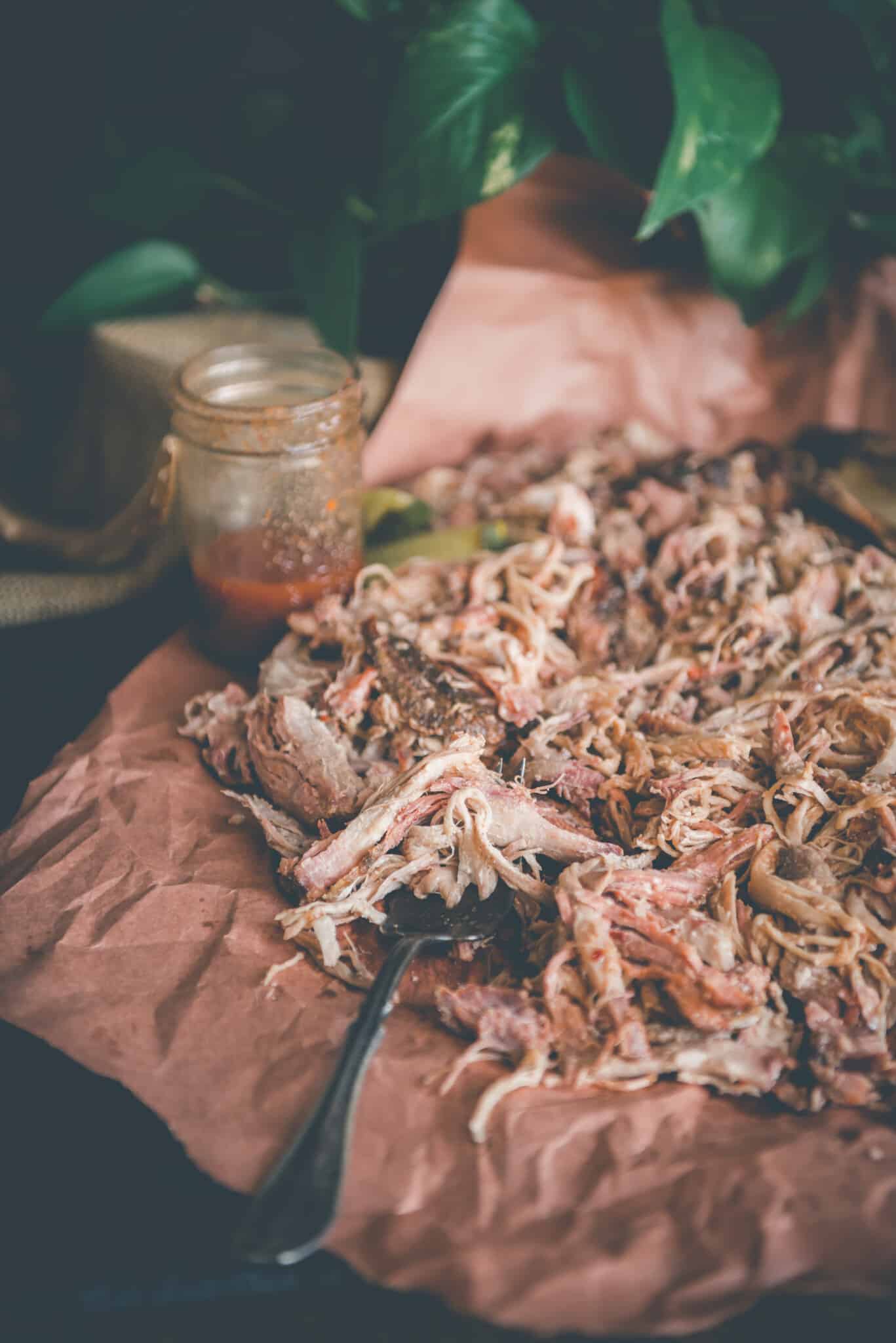 close up view of shredded pork butt on a plate