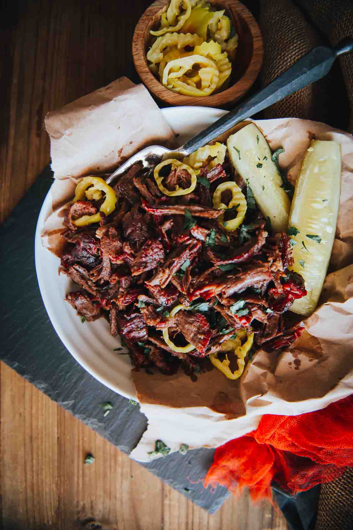 Smoked chuck roast, with a deep red smoke ring, pulled and in a serving bowl. 