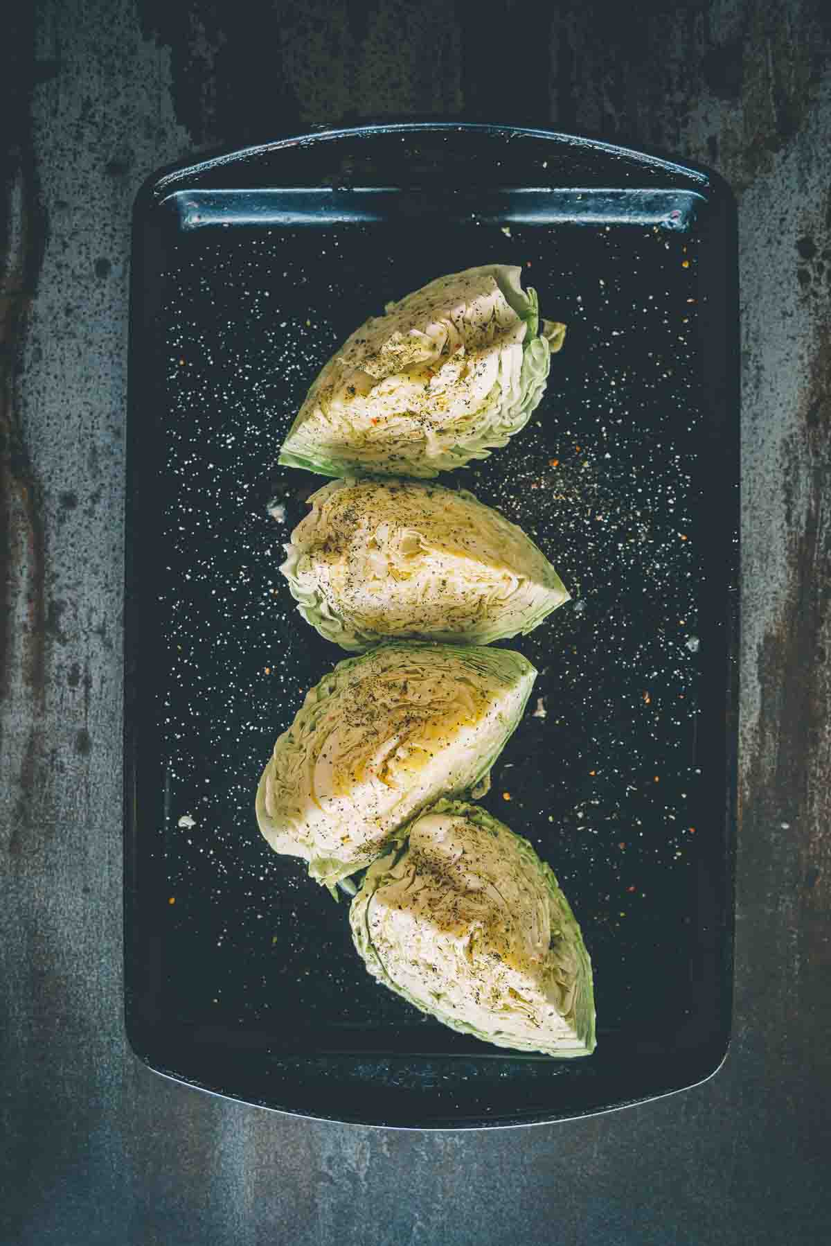 Above shot of cabbage wedges, core removed and seasoned. 