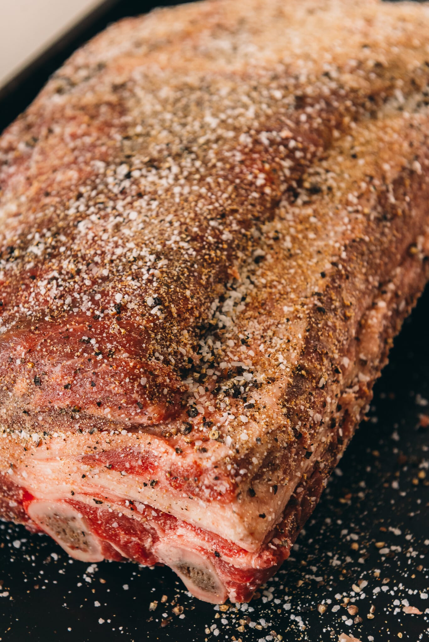 Close up of salt, pepper, garlic rub on beef ribs.