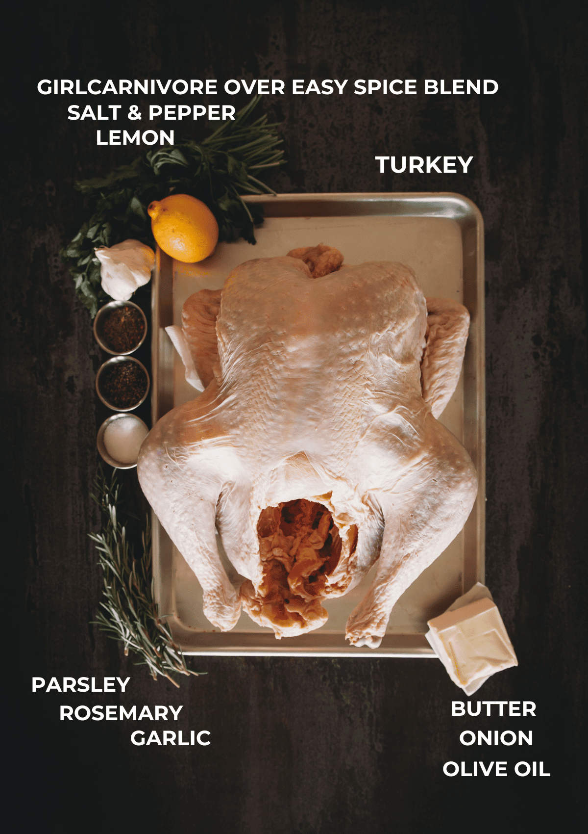 Ingredients for a smoked turkey arranged on a black board. 