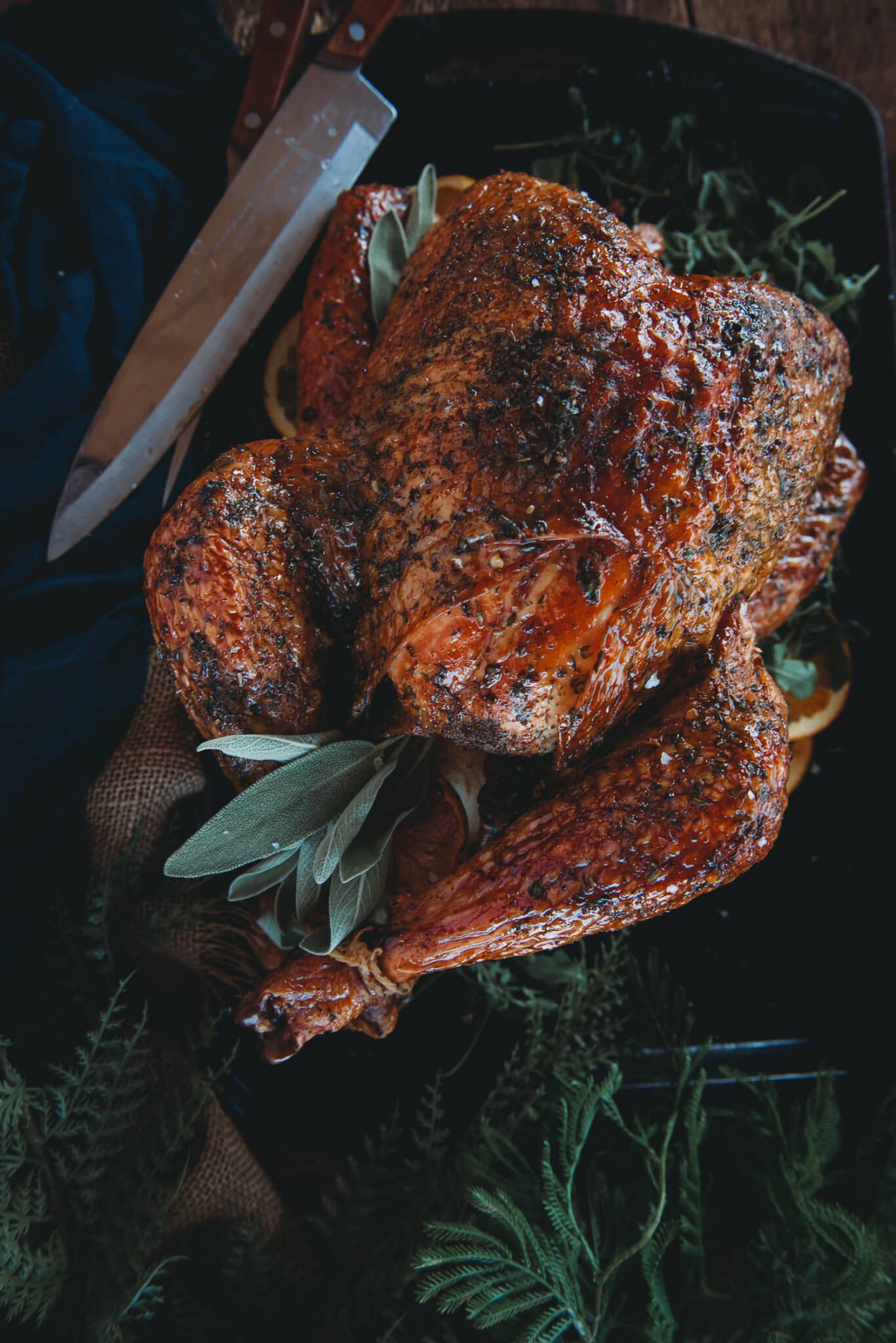 Smoked whole turkey on a cutting board waiting to be carved. 