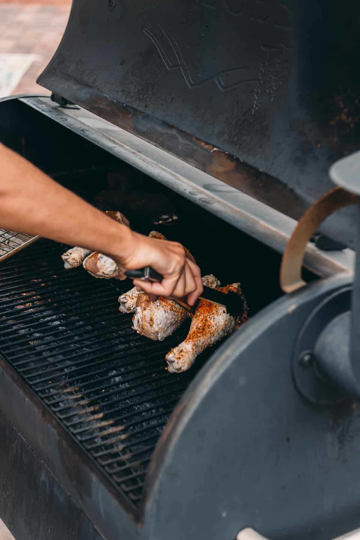 Placing the turkey legs on the smoker. 