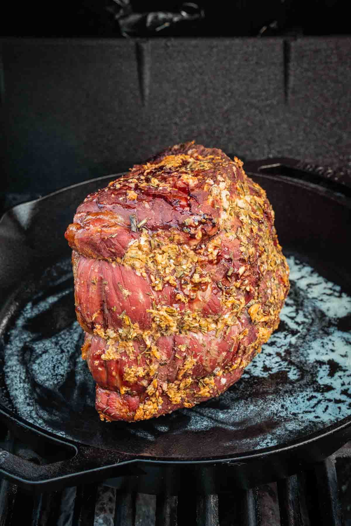 Showing the roast, in a cast iron skillet browning one edge. 