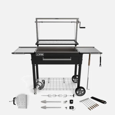 A black and silver outdoor grill with wheels, featuring a rotisserie system and side trays, makes the perfect grilling gift. Accessories include skewers, a rotisserie fork, and a control unit.