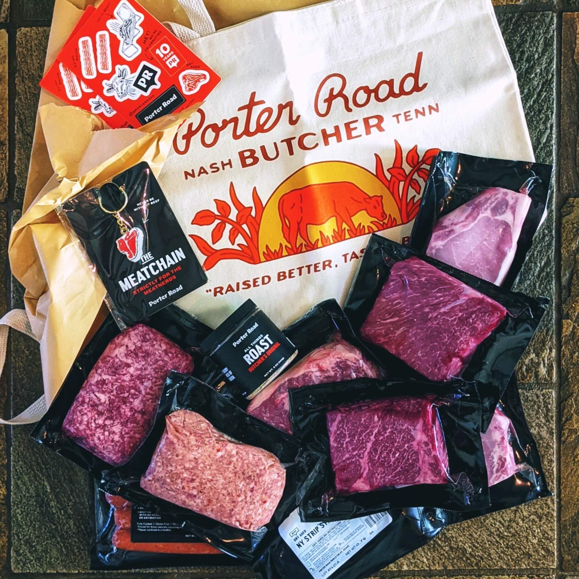 Variety of packaged meats in porter road packaging with bag to show branding.