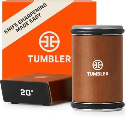 The "Tumbler" knife sharpener set, a perfect grilling gift, features a wooden cylindrical design. It sits beside an orange box labeled "Knife sharpening made easy," complete with a 20-degree angle guide for precision.