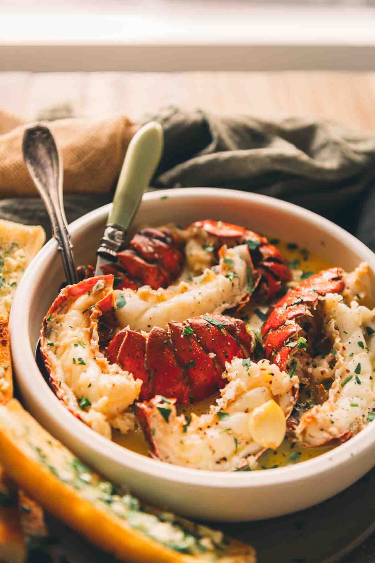 Lobster in a bowl of butter and garlic. 