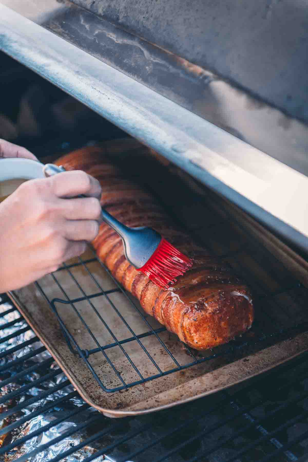 Brush basting meat. 