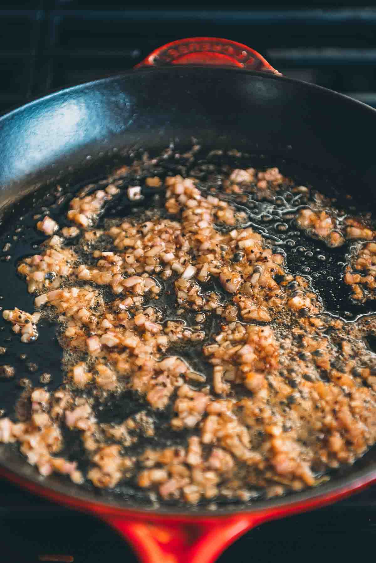 Minced shallots in a skillet.