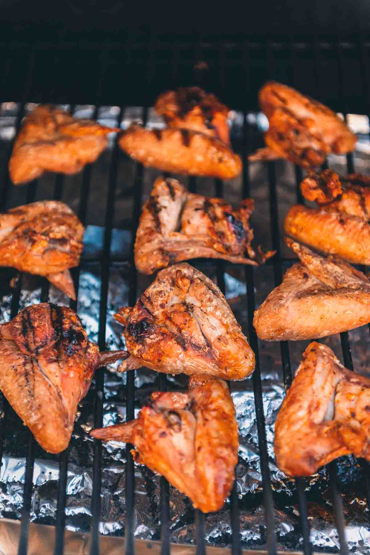 Grill makes on wings as they sit on a grill grate. 