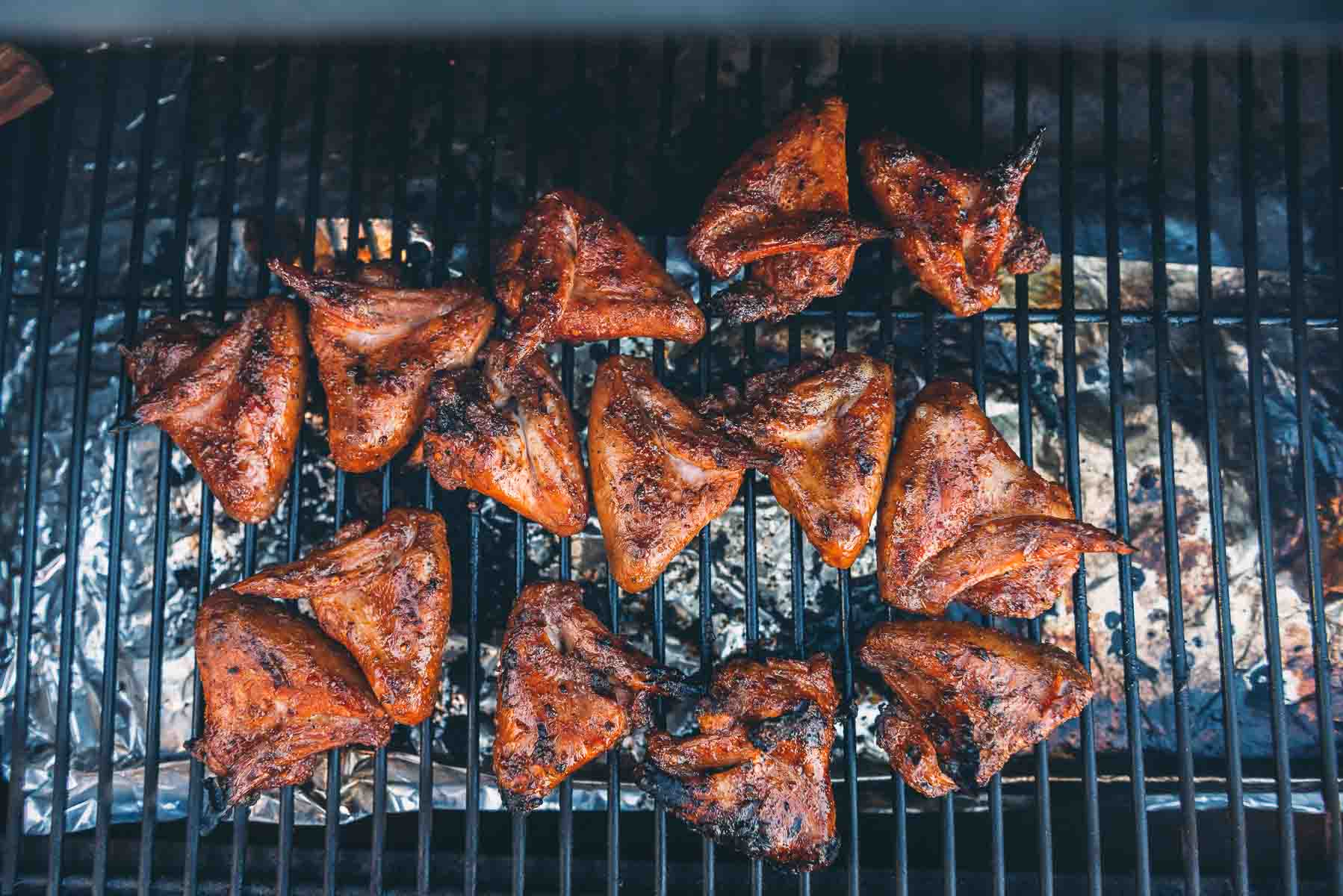 Chicken wings on a grill grate. 