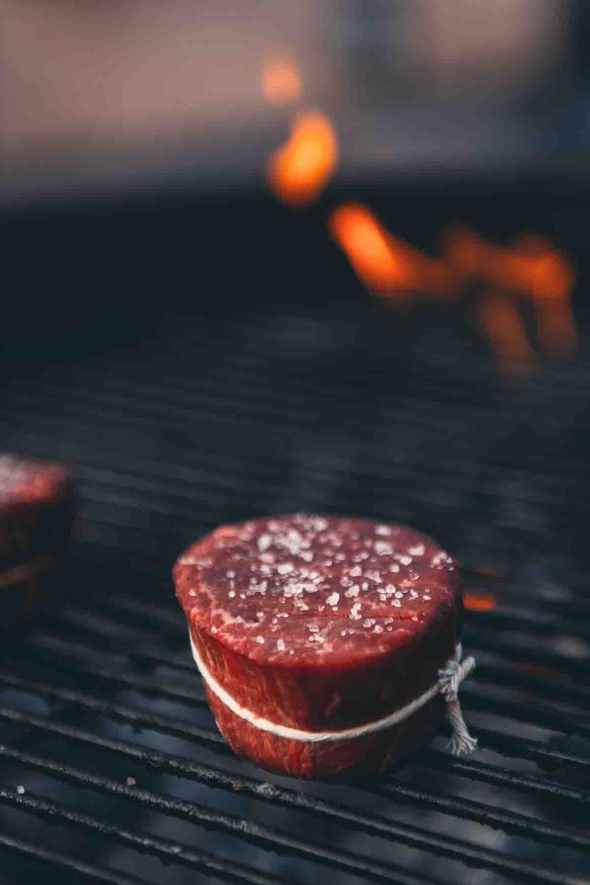 Raw filet on grill grates. 