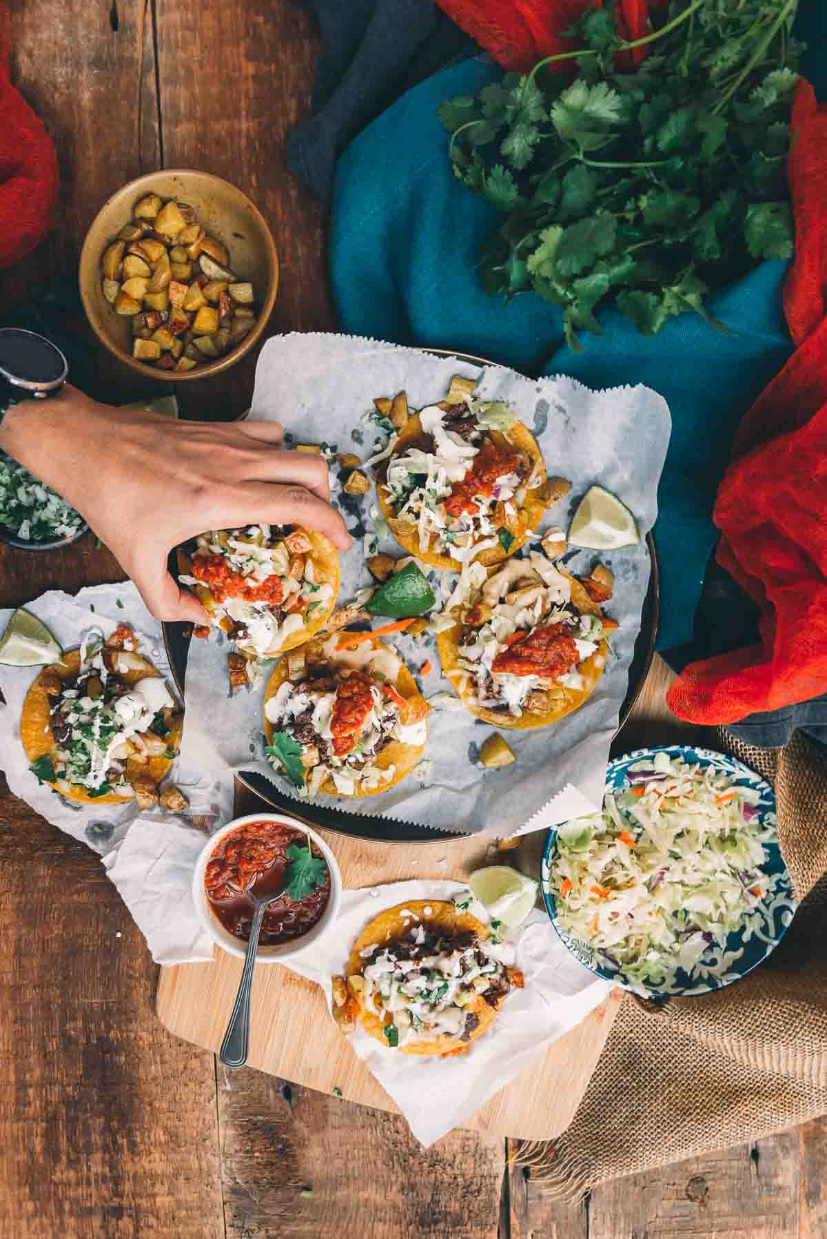 Hand reaching in to lift a garnacha from a platter.