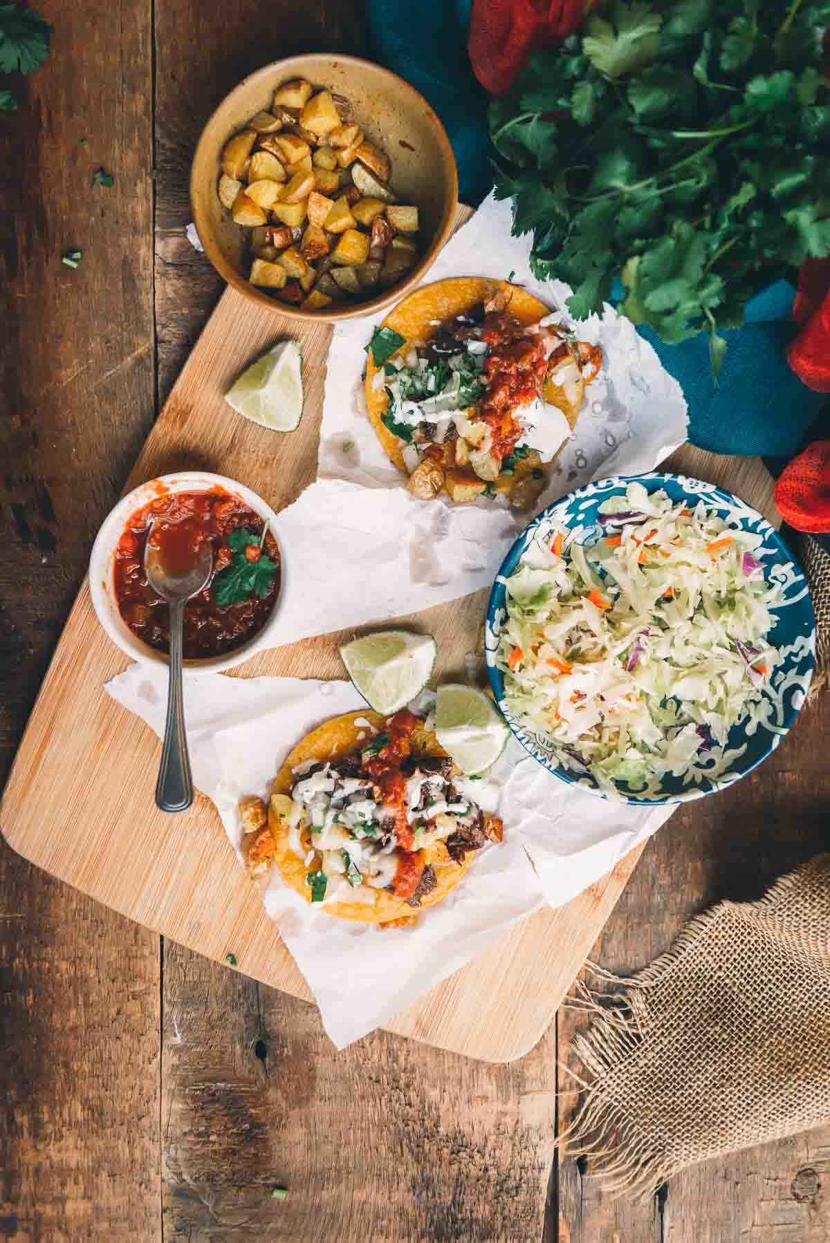 Fried tortillas topped with meat and additional toppings ready to be served. 