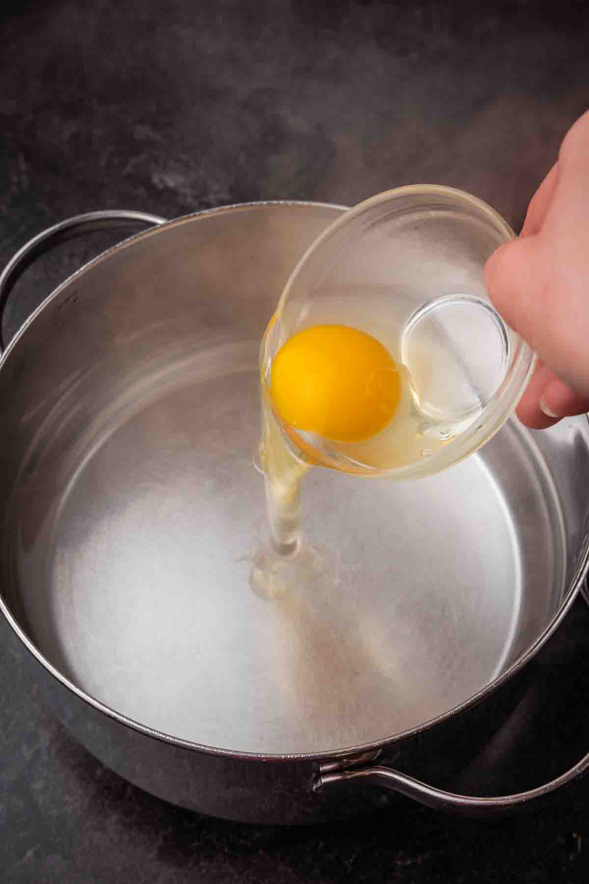 Egg yolk being dropped into hot water