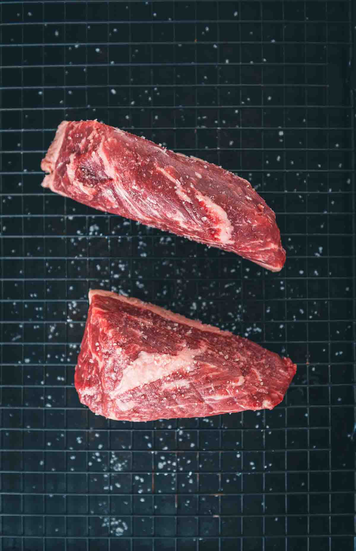 Close up to show salt on steaks. 