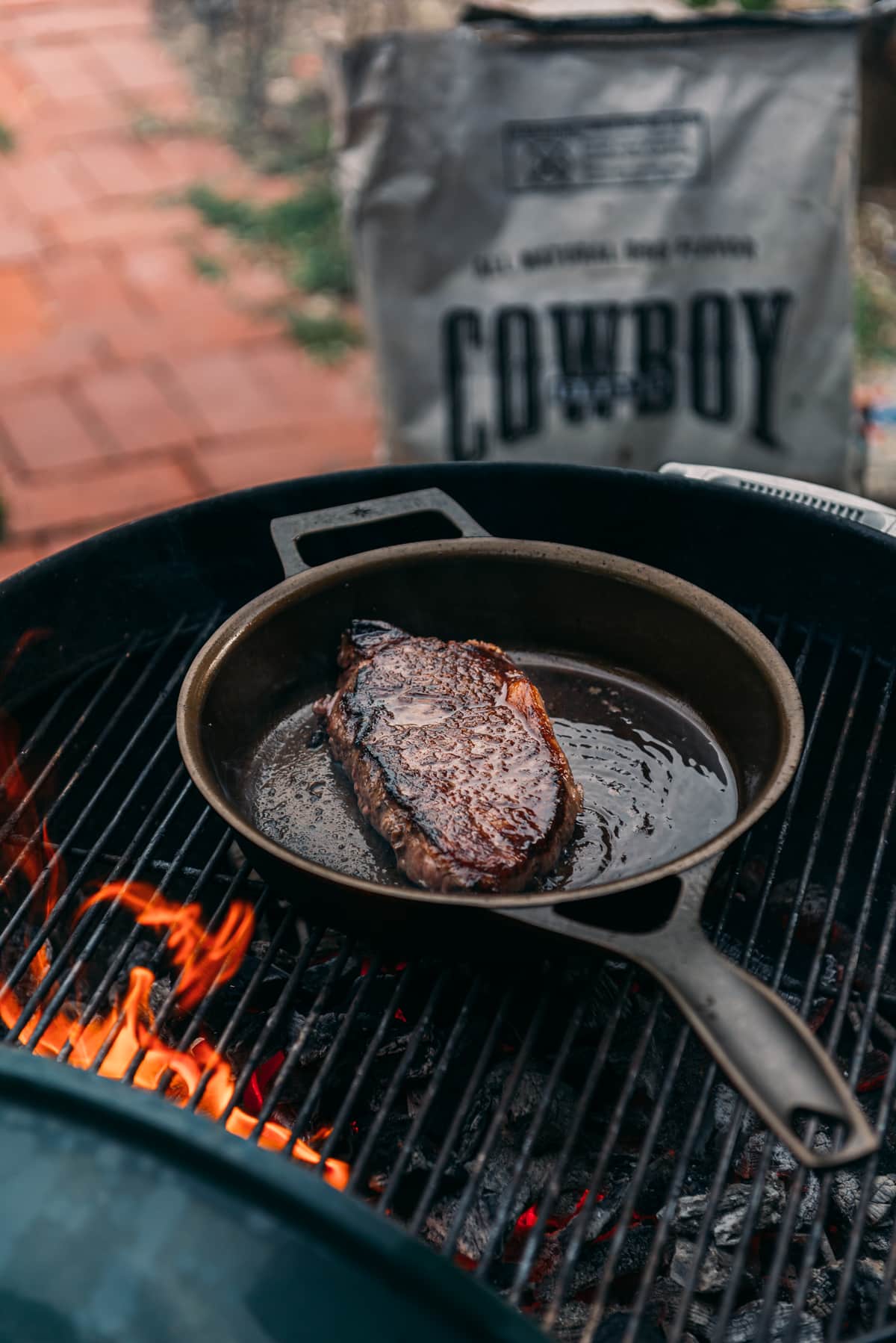 Steak in cast iron on a grill. 