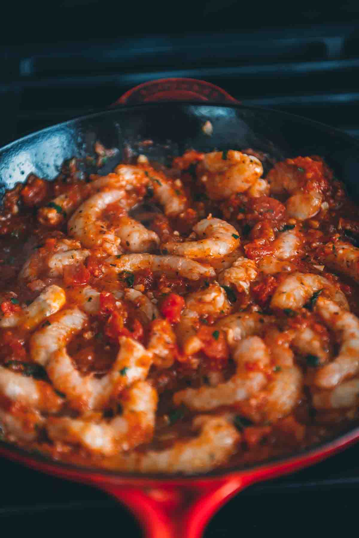 Shrimp simmering in tomato sauce. 