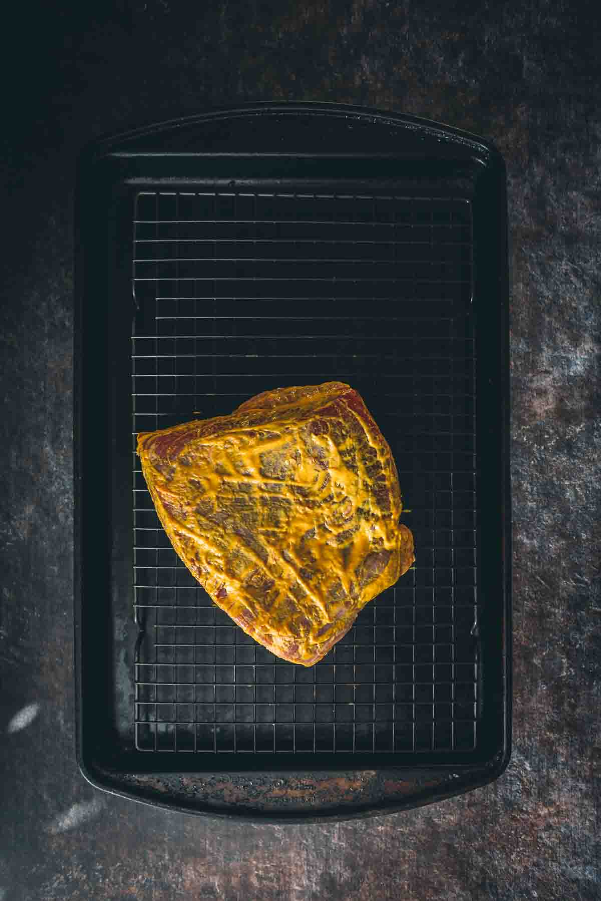 Mustard coating the meat. 