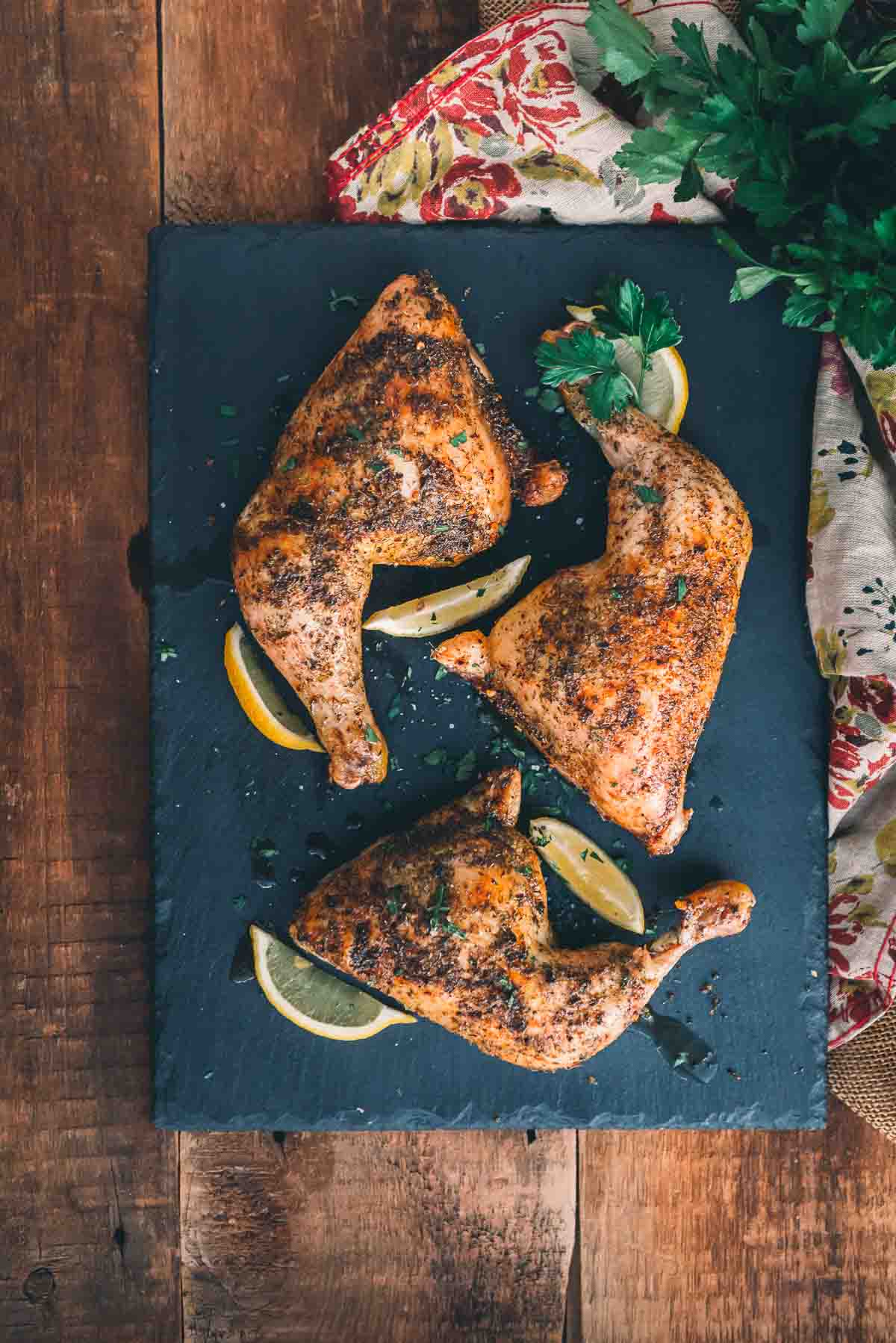 Roasted chicken legs on a serving platter. 