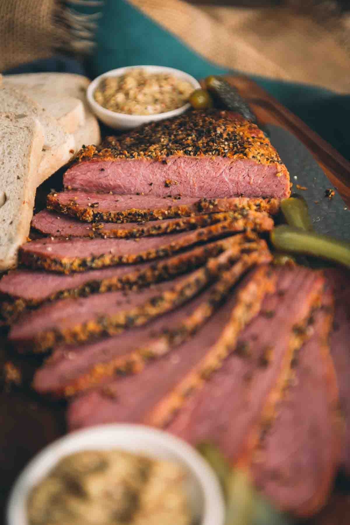 Close up showing the coarse pepper crust and pink slices of beef.