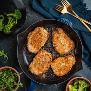 Shake and Bake Pork Chops cooked with broccoli in a skillet.