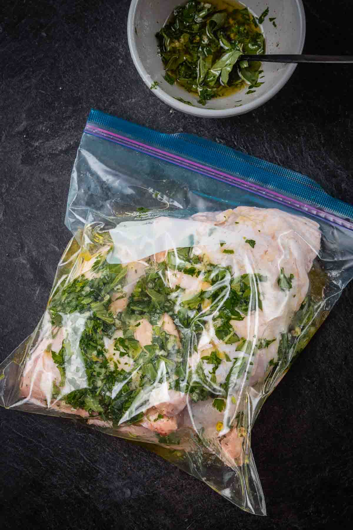 Chicken legs in a resealable bag marinating.