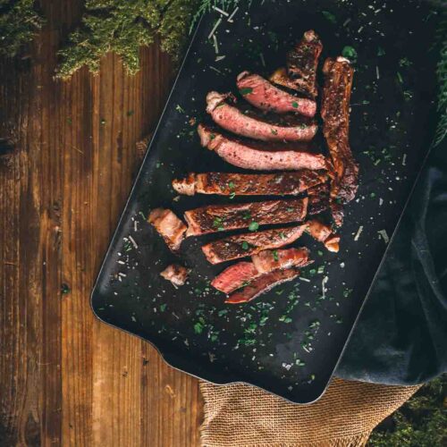 Sliced grilled ribeye on a serving platter.