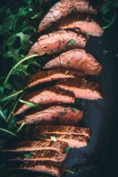 Close up of thin strips of sliced sierra steak.